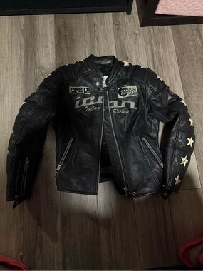 ICON Black Leather Motorcycle Jacket with Star Sleeve Accents